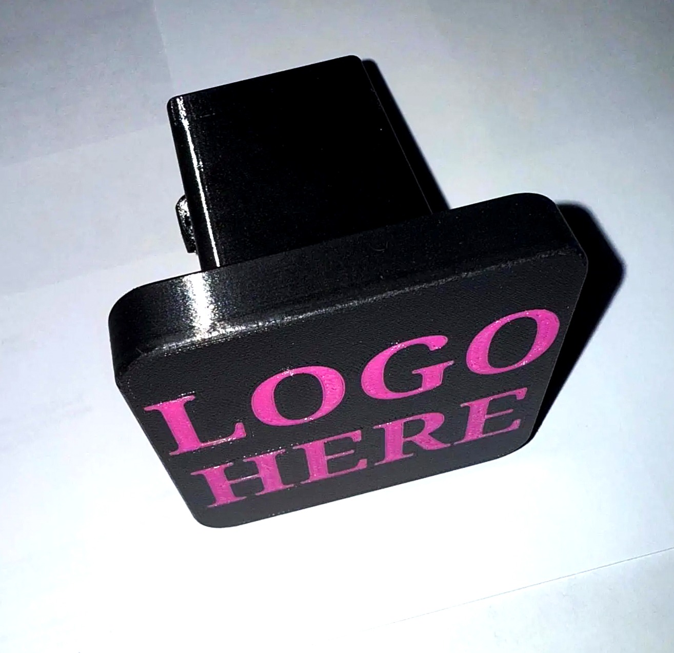 Custom 2-inch trailer hitch cover, angled studio photo showing the receiver plug and rounded finish